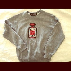 Grey swestshirt with sequined perfume bottle on it